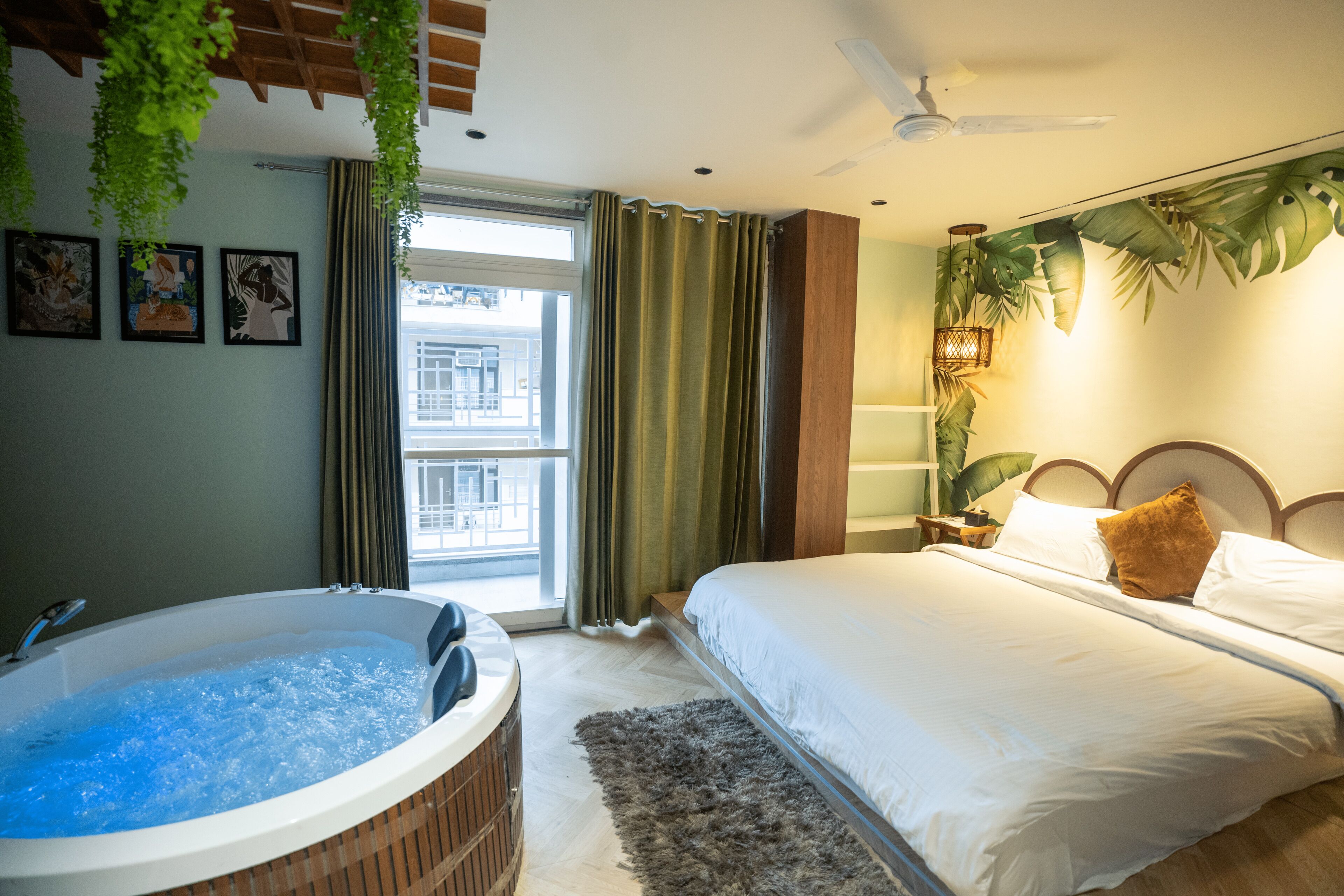 A bedroom with a large bed, a bathtub, and a window with curtains.