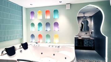 A modern bathroom with a large bathtub, a patterned floor, and a unique wall design with illuminated arches.