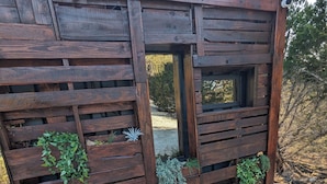 A wooden garden structure with various plants and rocks. - Lost Horizon Texas (Kempner)