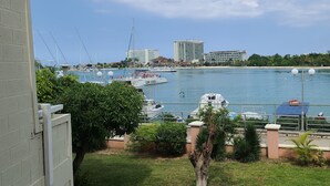 A marina with boats, a building, and a clear sky. - Fisherman's Point Ocho Rios (Ocho Rios)