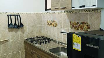 Fridge, microwave, coffee/tea maker, cookware/dishes/utensils