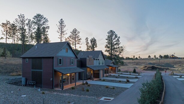 A two-story house with a garage, a driveway, and a landscaped garden. - Mt Rushmore Retreat hosted by Rockerville Gold Town Lodging • 8 Min Drive | 2 Bedroom Sleeps 6- Fireplace (Rockerville)