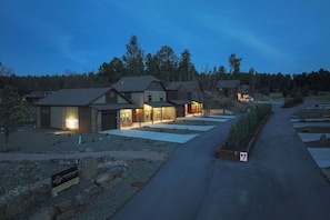 A residential area with houses, a driveway, and a sign indicating a rental property.