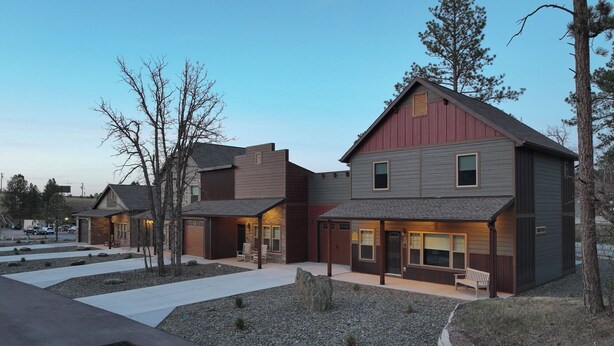 A modern residential complex with multiple houses, paved walkways, and a clear sky. - Homestake Haven Hosted by Rockerville Gold Town Lodging-Black Hills Base Camp-2 Bedroom, King Suite (Rockerville)