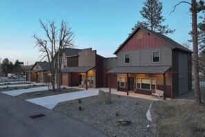 A modern residential complex with multiple houses, paved walkways, and a clear sky. - Homestake Haven Hosted by Rockerville Gold Town Lodging-Black Hills Base Camp-2 Bedroom, King Suite (Rockerville)