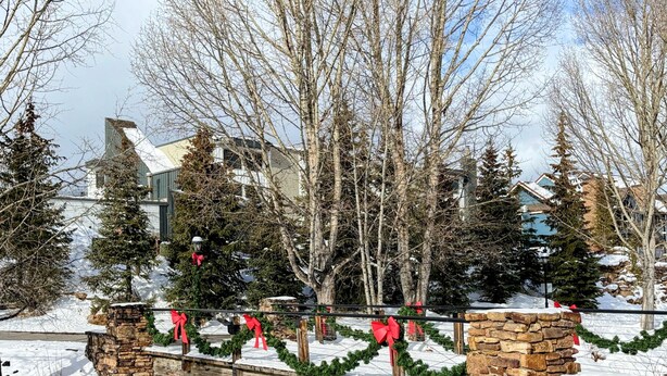 A stone bridge with snow-covered ground and bare trees. - Center of Downtown Breck, walk to slopes and Main Street! Steps to Riverwalk. (Breckenridge)
