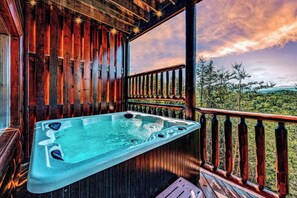 A hot tub on a wooden deck with a view of a forested landscape. - Autumn Getaway With Mountain Views (Sevierville)