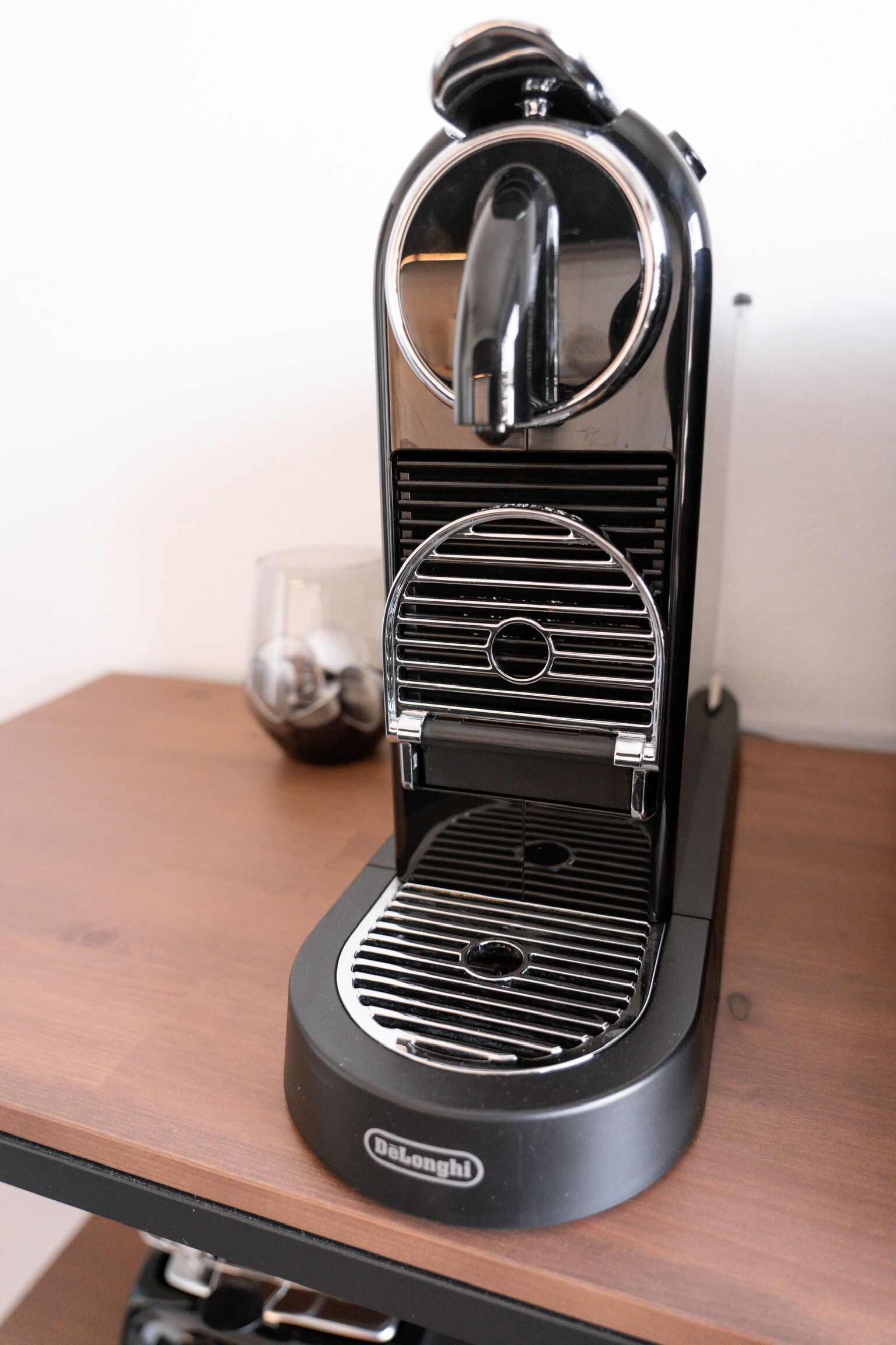 Une machine à expresso De'Longhi sur une table en bois.