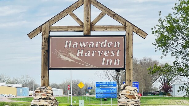 A wooden sign with the text "Hawarden Harvest Inn" supported by stone pillars. - Hawarden Harvest Inn (Hawarden)