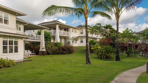 A residential area with multiple houses, a well-maintained lawn, and a pathway. - Light and Airy North Shore Condo. Owner hosted w/on site Co-host!  (Princeville)