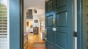 A teal door with a brass handle and a sign that reads "EMILY'S HOME." - Stunning Marin County home with pool (San Anselmo)