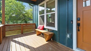 A wooden deck with a bench and a door with a peephole. - Stylish Chattanooga Retreat Minutes to Downtown (Chattanooga)