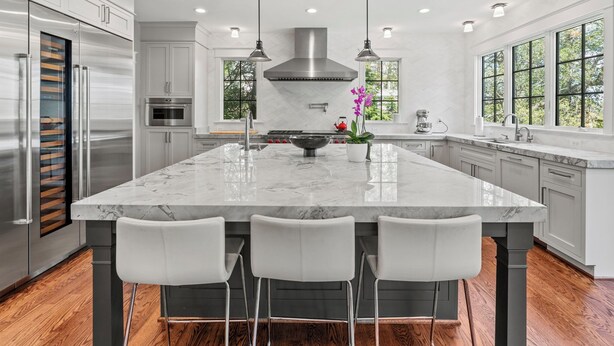 A modern kitchen with a large island, stainless steel appliances, and pendant lighting. - Glebe Getaway House (Arlington)