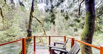 Unwind in nature's embrace at a 1925 cabin with hot tub & river views