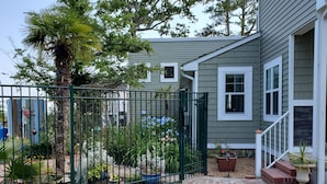 A residential property with a fenced garden, a pathway leading to the house, and a small porch area. - Edgewater Pirates Den. Water Front 2nd story apt.  1 bedroom, bath & kitchen.
 (Hertford)