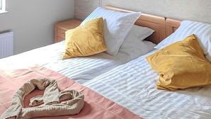 A double bed with two pillows, a bedside table, and a pink blanket. - Nice home in Kilder with kitchen (Kilder)