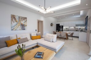 Suite, Private Pool | Living area | 50-inch LED TV with premium channels - Pomaria Boutique Residences  (Lefkada)