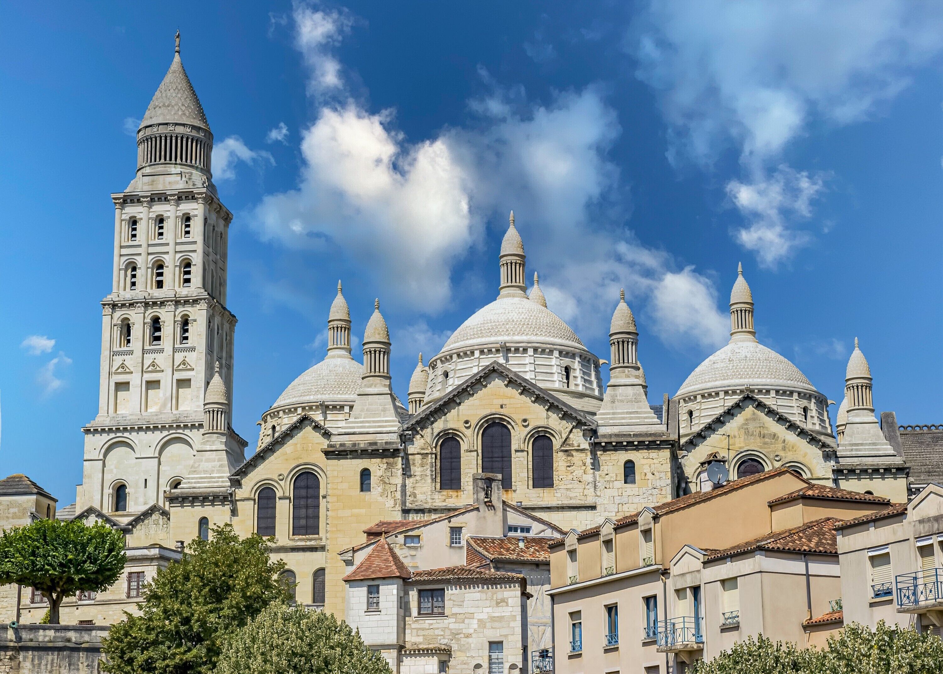 A historic building with multiple domes and a bell tower.
