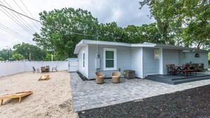 Uma casa móvel com área de pátio, mobiliário para áreas externas e um pequeno deck.
