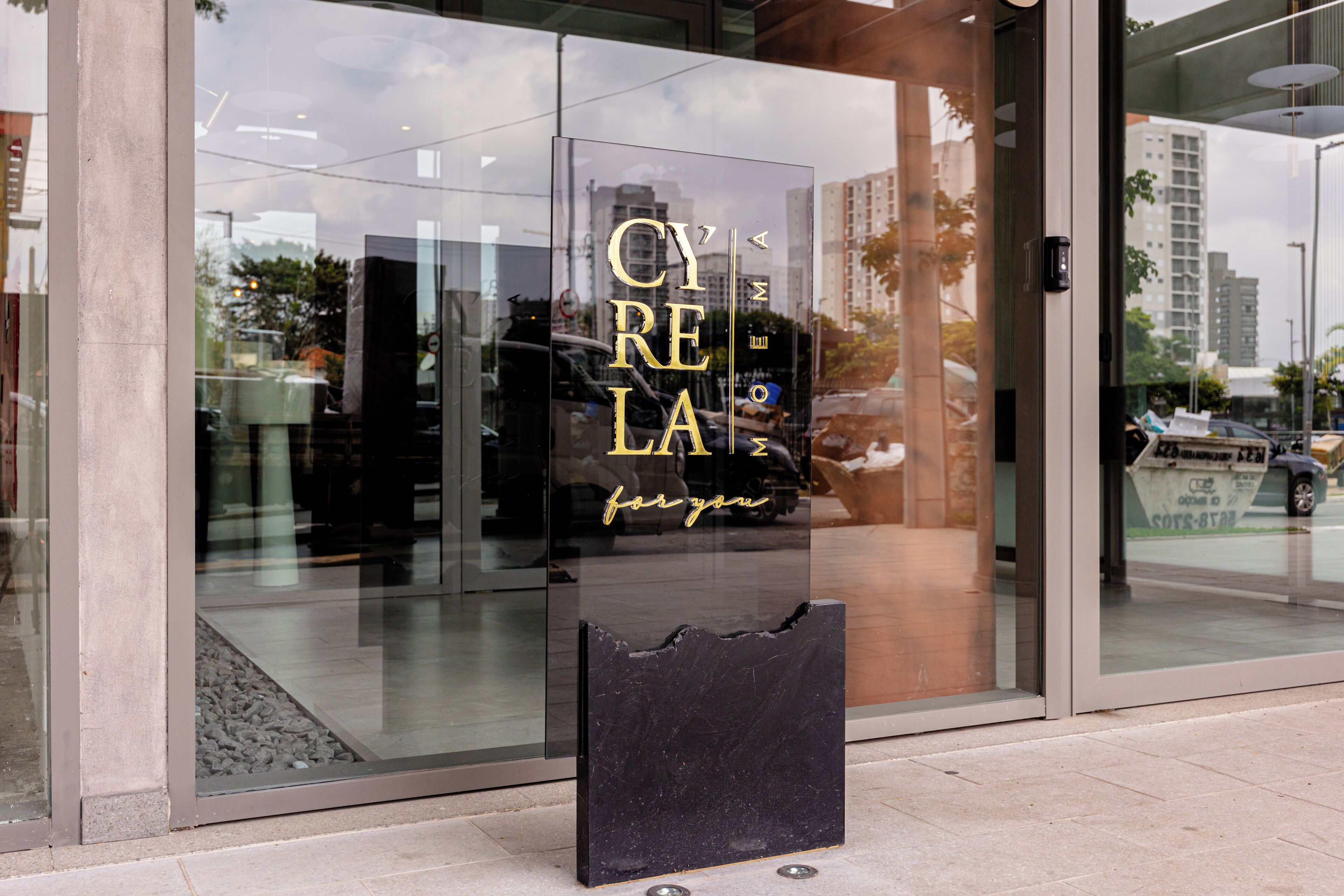 A glass storefront with the text "CYRELA" and "for you" visible.