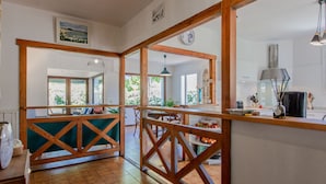 A spacious kitchen with wooden accents, a dining area with a view, and a balcony with a view.