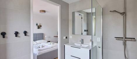 Shower, hair dryer, towels, toilet paper
