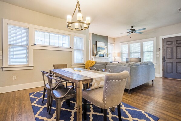 Relax in this inviting living area with a dining table for four, comfortable sofa, and fireplace.