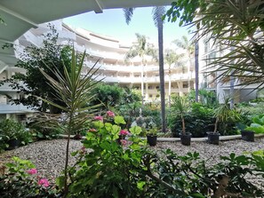 Surrounded by lush greenery, this courtyard offers a serene atmosphere.