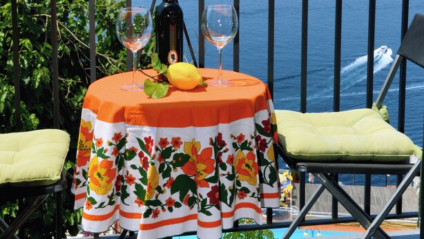 A balcony with a table set for two, overlooking the sea. - Ancient mansion with breathtaking views amid ancient olive and citrus trees (Praiano)