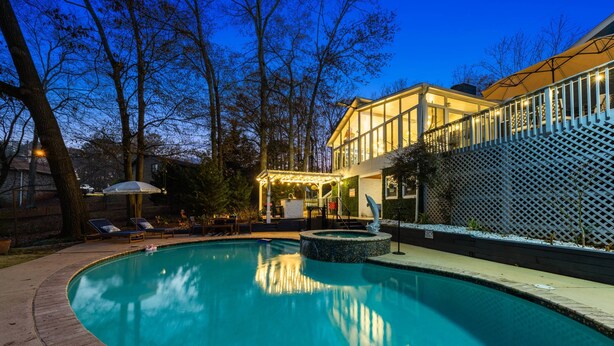 A swimming pool with a sunken area, surrounded by lounge chairs and a covered seating area. - Pool, Tree House, Kids Game Room, Grilling & 20 Minutes to Atl Attractions (Lilburn)