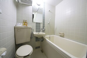 A small, clean bathroom with a toilet, sink, and bathtub. - Hotel Public21 (Usa)
