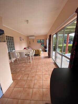 Relax in this stylish living area with a sofa set, dining table, and outdoor access.
