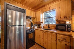 Fridge, microwave, stovetop, cookware/dishes/utensils