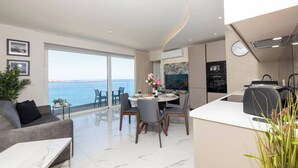 A modern apartment with a balcony, a dining area, and a kitchen.