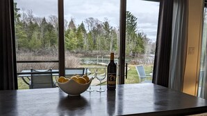 A table with a bowl of lemons, a bottle of wine, and two glasses. - Waterfront close to Traverse City, Kayaks, Row Boat, Firepit, Dog ok, 8pl (Traverse City)