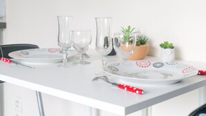 A dining table set with plates, glasses, and cutlery.