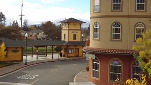 A building with a curved facade, a clock tower, and a sign that reads "HITZMAN'S DINE".