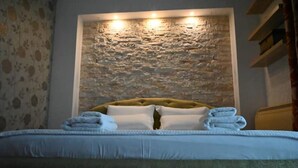 A bed with a headboard, pillows, and folded towels. - Neo Classic Villa: Garden, Playground & Biodesign Pool (tirane)