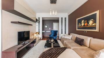 Superior Apartment | Living area | 50-inch LED TV with satellite channels