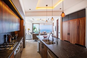 The kitchen amenities include a full-size fridge, stove, oven and dishwasher - Oceanview Luxury: 2 BR in Amapas w/ Rooftop Pool (Puerto Vallarta)