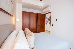The cozy guest bedroom features a dedicated workspace and ample closet space - Oceanview Luxury: 2 BR in Amapas w/ Rooftop Pool (Puerto Vallarta)