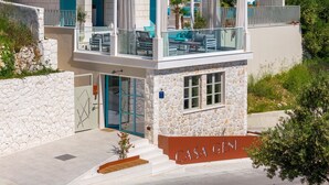 A modern building with a stone facade, a glass entrance, and a sign reading "CASA GENI". - Casa GENI with a heated pool, 3 bedrooms, an organic garden, sea views (Borak)