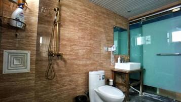 A modern bathroom with a shower, toilet, and sink.