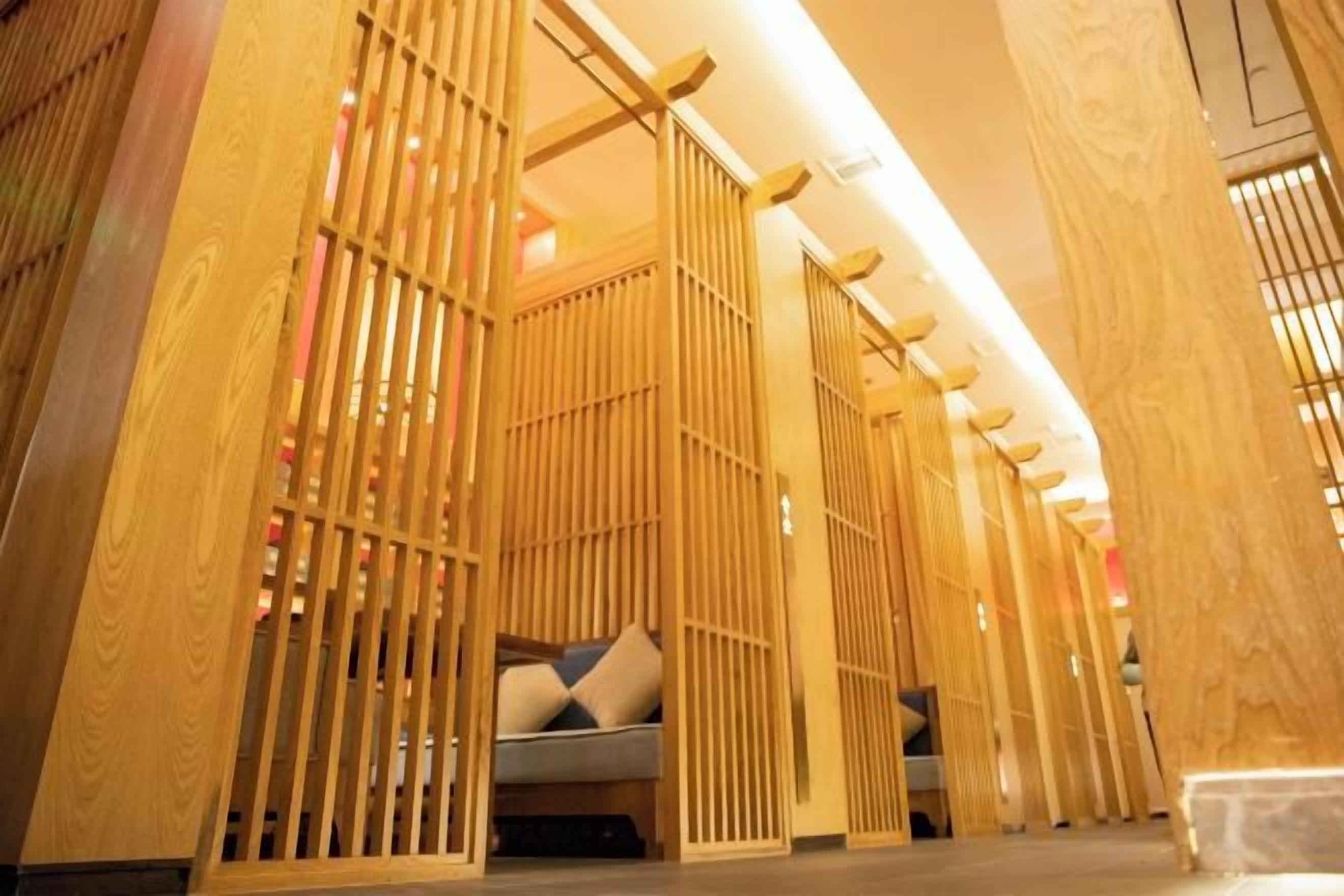 A room with a traditional Japanese sliding door, a bed with pillows, and a wooden floor.