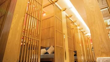 A room with a traditional Japanese sliding door, a bed with pillows, and a wooden floor.