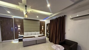 A modern living room with a sofa, a coffee table, and a wall-mounted TV. - Presken Waters (Lagos)