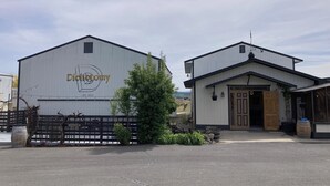 A building with a sign reading "Dichotomy" and a smaller adjacent structure. - Vineyard views at Dichotomy Vineyards guest house in the Yakima Valley (Outlook)
