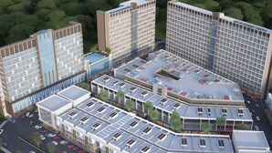 A high-rise building complex with multiple floors, a rooftop parking area, and a surrounding green area. - Favehotel Nagoya - Batam (Nagoya)
