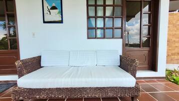 Una habitación con una cama, un cuadro, una ventana y una puerta.