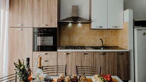 Een moderne keuken met houten kastjes, een gasfornuis en een ingebouwde oven.